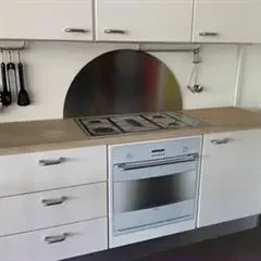 Stænkplade i bueform 60x30 cm. Børstet stål.